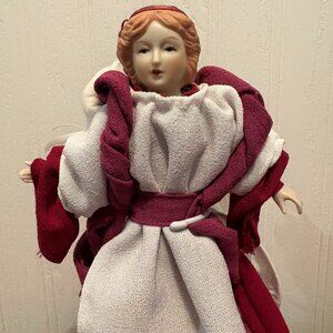 Angel with porcelain head, hands feet with stand; Wings are feathers, 10" tall